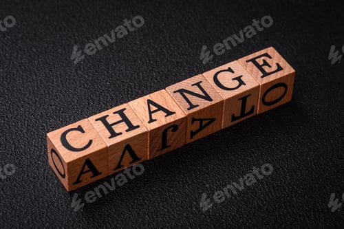 Preview: The inscription chance or change with wooden cubes on a dark concrete background