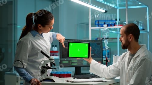Preview: Scientists using tablet with green chroma key screen, talking