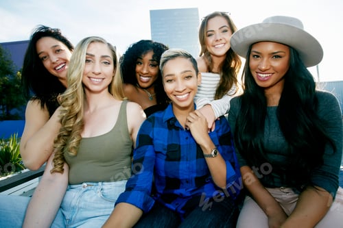 Preview: A group of young women partying on a city rooftop at dusk