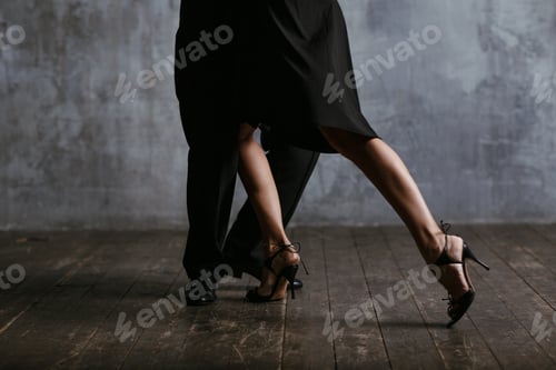 Preview: Man and woman in black dress dance tango