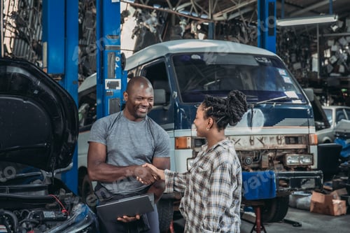 Preview: Friendly Handshake Between Mechanic and Customer in Busy Automobile Workshop