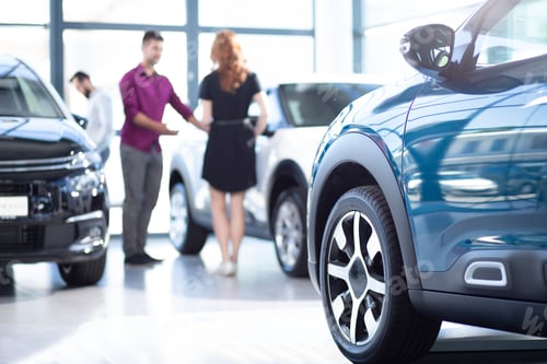 Preview: Low angle of exclusive car in a dealing salon with seller and bu