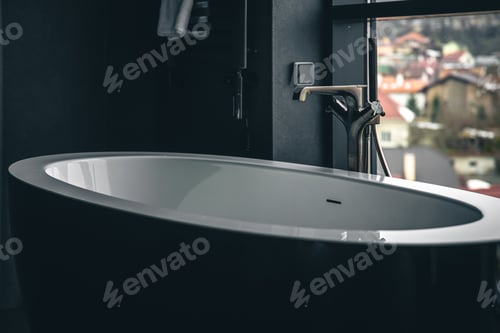 Preview: Bathtub in the interior of the bathroom with a window.