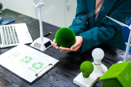 Preview: An Asian businesswoman sits at her desk, discussing clean energy solutions their impact on homes