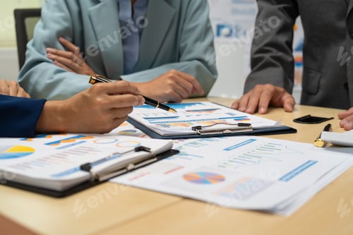 Preview: A businessperson financial analyst during corporate meeting. review a graph document,discussing