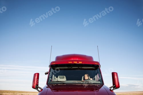 Preview: View of a Caucasian woman driver in the cab of her commercial truck.