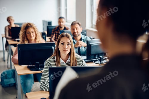 Preview: Mid adult woman attending computer class in the classroom.