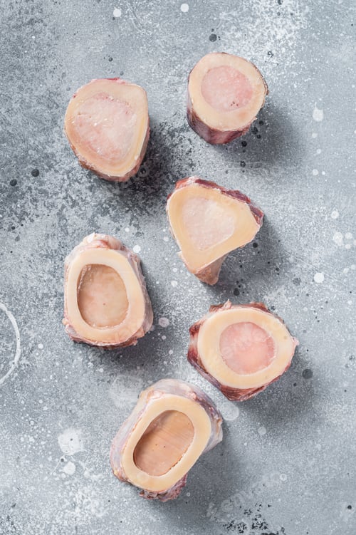 Preview: Raw calf Marrow bones on butcher table. Gray background. Top view