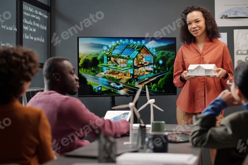 Preview: Young female speaker with model of house