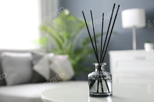 Preview: Aromatic reed air freshener on white table in room. Space for text