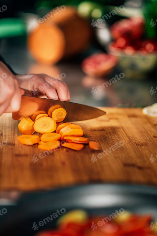 Preview: Preparing Vegan Meal - Chef Cutting Carrot on Wooden Cutting Board
