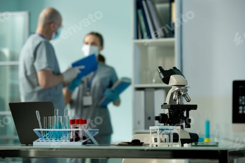 Preview: Workplace of scientist or laboratory worker with group of flasks and microscope
