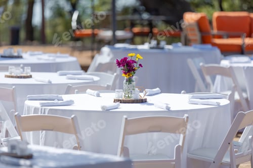 Preview: Elegant outdoor event setup with floral centerpiece.