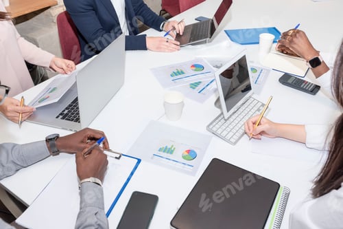 Preview: Teamwork with business people analyzes the cost chart on the desk in the meeting room