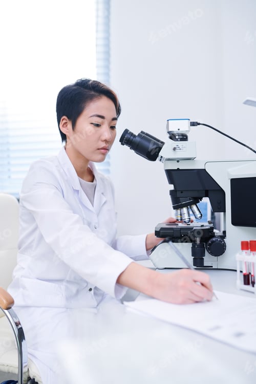Preview: Asian biologist studying cells with microscope