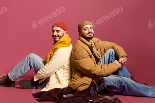 Preview: Twins showcase stylish fashion with vibrant colors and cozy layers in a creative setting
