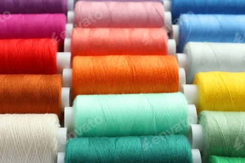 Preview: Set of different colorful sewing threads as background, closeup