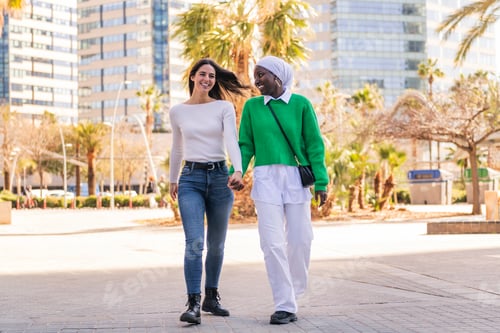 Preview: couple of two women walking holding hands
