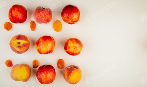 Preview: top view of pattern of sliced and whole peaches on left side and white background with copy space