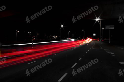 Preview: Aerial view of road with red light trails
