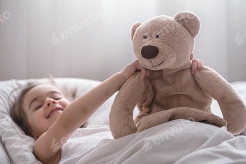 Preview: Little cute girl in bed with toy