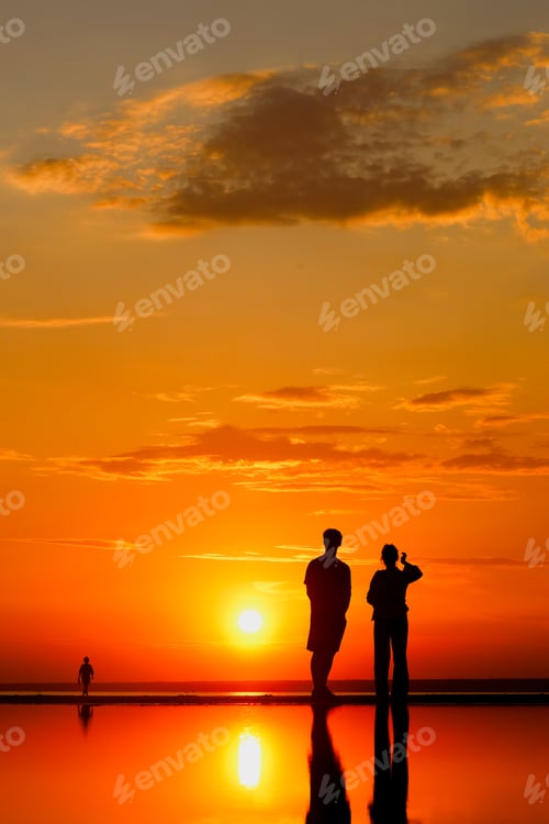 Preview: Silhouettes of people against sky seascape sunset sky on sea or ocean