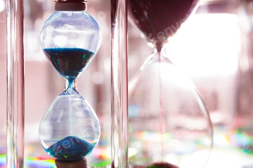 Preview: Blue hourglass on gray background close up