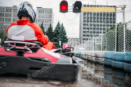 Go kart driver on start line, back view