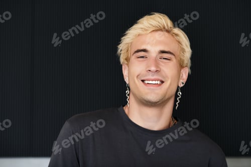 Preview: Handsome young man with blonde hair smiles brightly in modern apartment setting