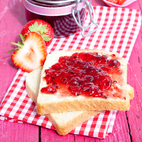 Preview: Closeup shot of toasted bread with strawberry jam
