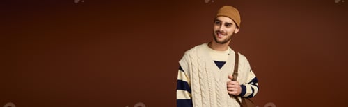 Preview: Stylish young man embraces modern fashion with trendy beanie and cozy knitwear