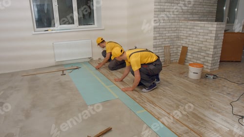 Preview: Men in the uniform laying laminate.