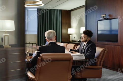 Preview: Biracial Jurists Doing Paperwork in Team Sitting in Office