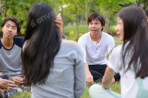 Preview: Happy young group of friends having fun together at the park