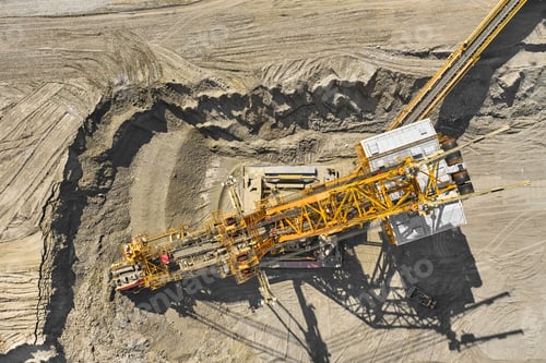 Preview: Aerial view of large heavy equipment machine mining natural resource. Coal mining by bucket wheel