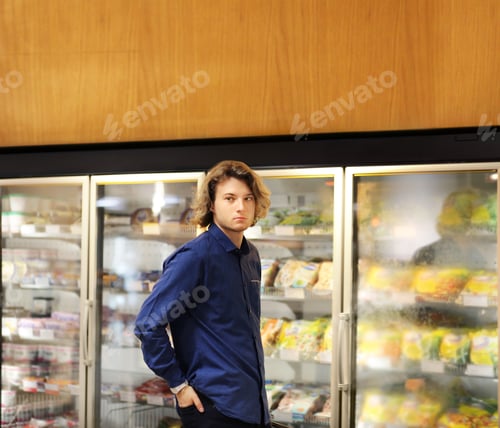 Preview: Man Choosing Frozen Food From A Supermarket Freezer