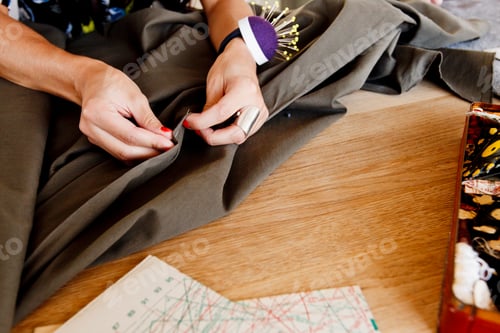 Preview: Cropped view of seamstress pinning fabric