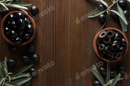 Preview: Olives in wooden bowls on wooden background, space for text