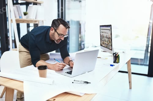 Preview: Ill find what Im looking for online. Shot of a mature male architect working on his laptop.