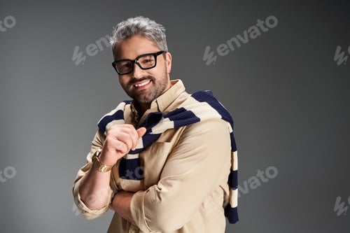 Preview: Handsome man in stylish glasses poses confidently in trendy studio setting