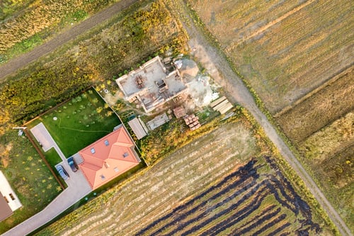 Preview: Top down aerial view of two private houses, one under construction