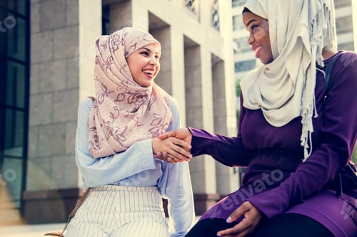 Preview: Islamic friends handshaking and smiling