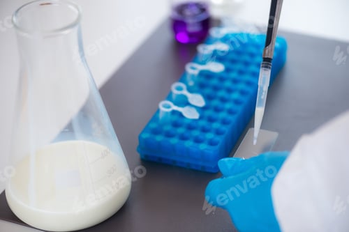 Preview: An expert assesses milk quality in a laboratory, using test tubes for analysis.