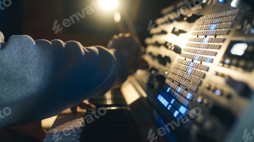Preview: Hands of a man sound engineer are pressing buttons on the console