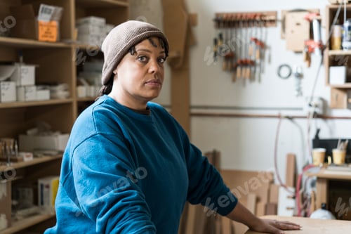 Preview: Portrait of a Black woman carpenter in a large woodworking shop.