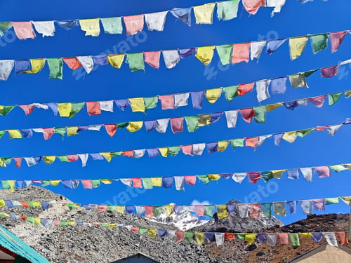 Preview: Tibetan prayer flags flutter against a clear blue sky, high in the Himalayas