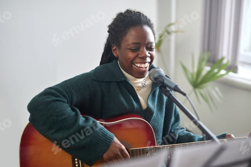 Preview: Happy woman playing the guitar and singing
