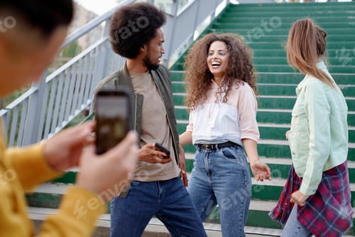 Preview: Man taking pictures of his dancing friends