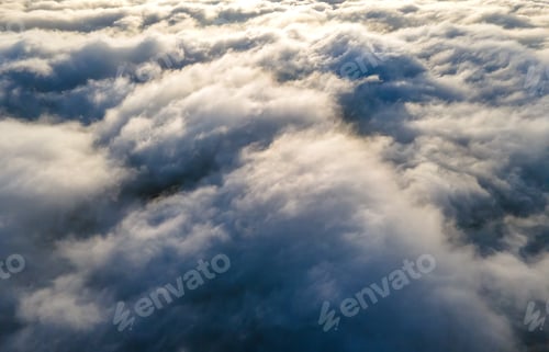 Preview: Aerial view over surface of white dense clouds at sunset