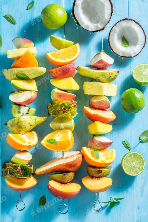 Preview: Colorful Fruit Skewers on Blue Wooden Background